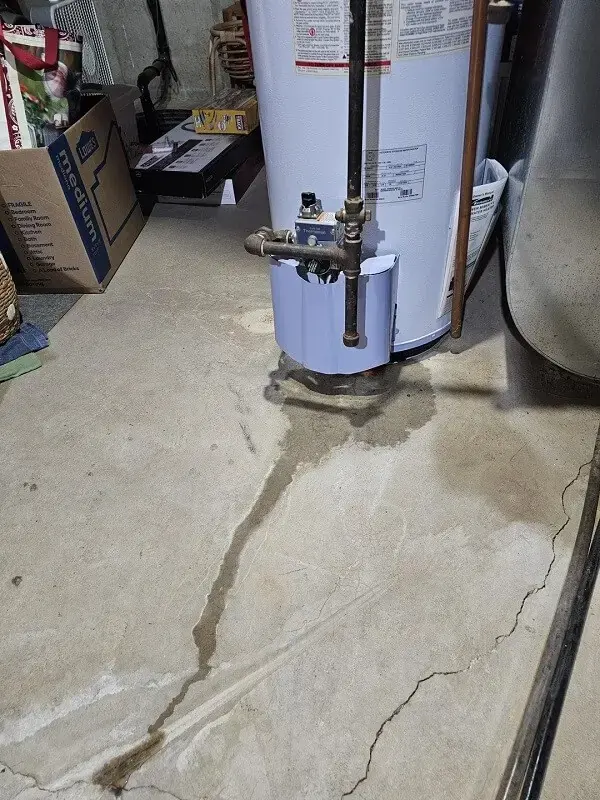 Water spreading across a basement slab from a failed water heater in O'Fallon
